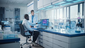 technicians-working-in-laboratory-with-computer-monitor