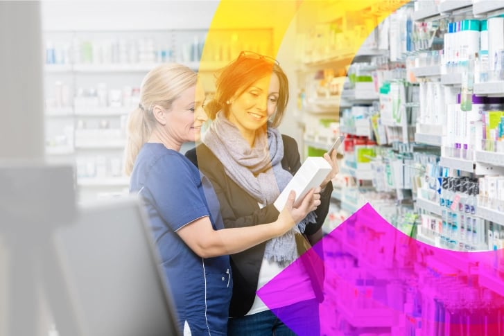 chemist-showing-product-to-customer-holding-cell-phone-in-pharma