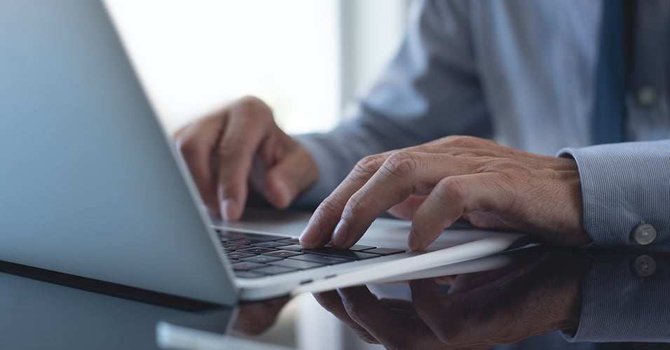 hands-of-regulatory-professional-typing-on-computer